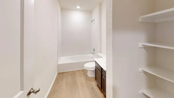 a bathroom with a toilet and a bathtub