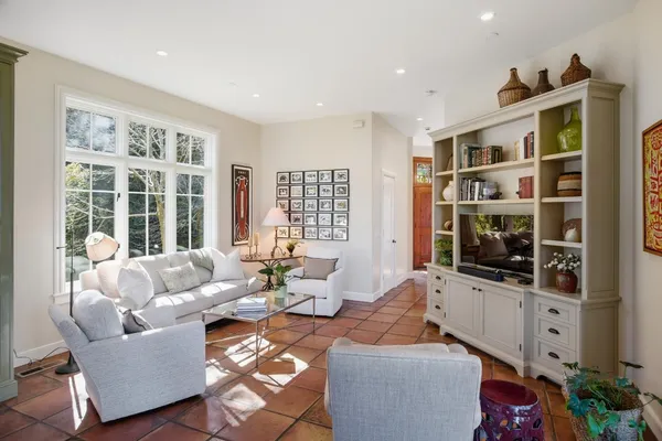 a living room with furniture fireplace and flat screen tv