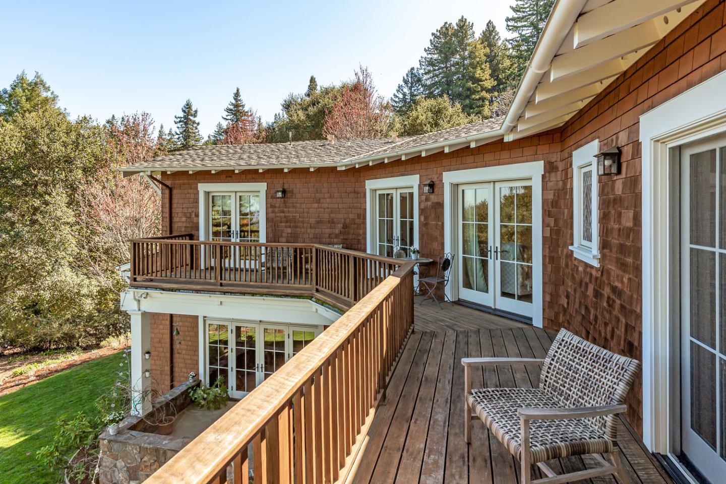 950 Espinosa Road Woodside, CA 94062 - Photo 15 of 24 a balcony of a house with wooden floor outdoor seating and yard in the back