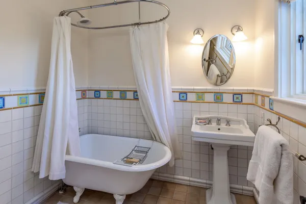 a bathroom with a sink bathtub and a window