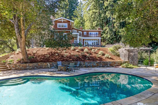 a swimming pool with outdoor seating and yard