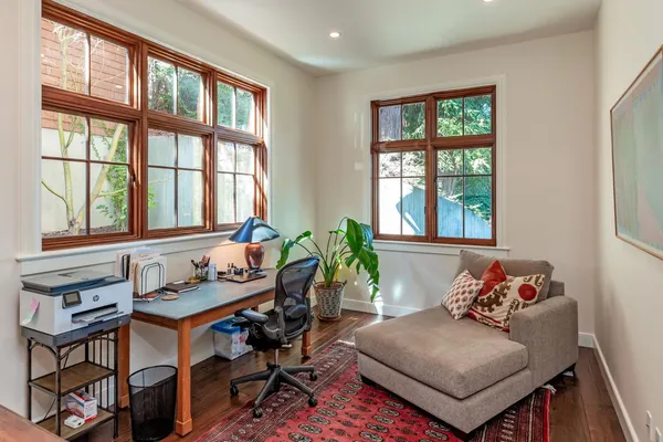 a living room with furniture and two windows