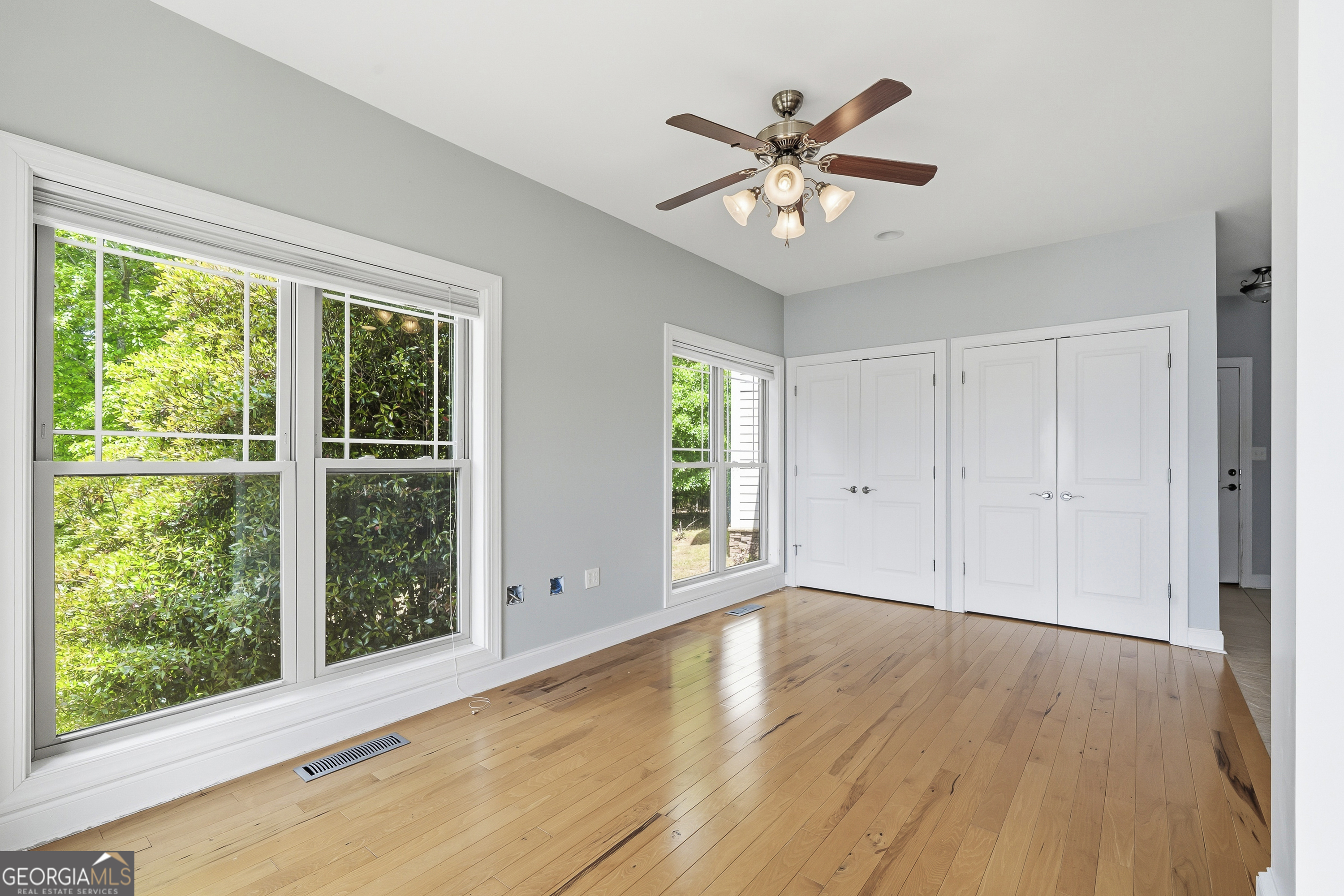 1038 Dennis Station Road Southwest Eatonton, GA 31024 - Photo 30 of 72 a view of an empty room with wooden floor and a window