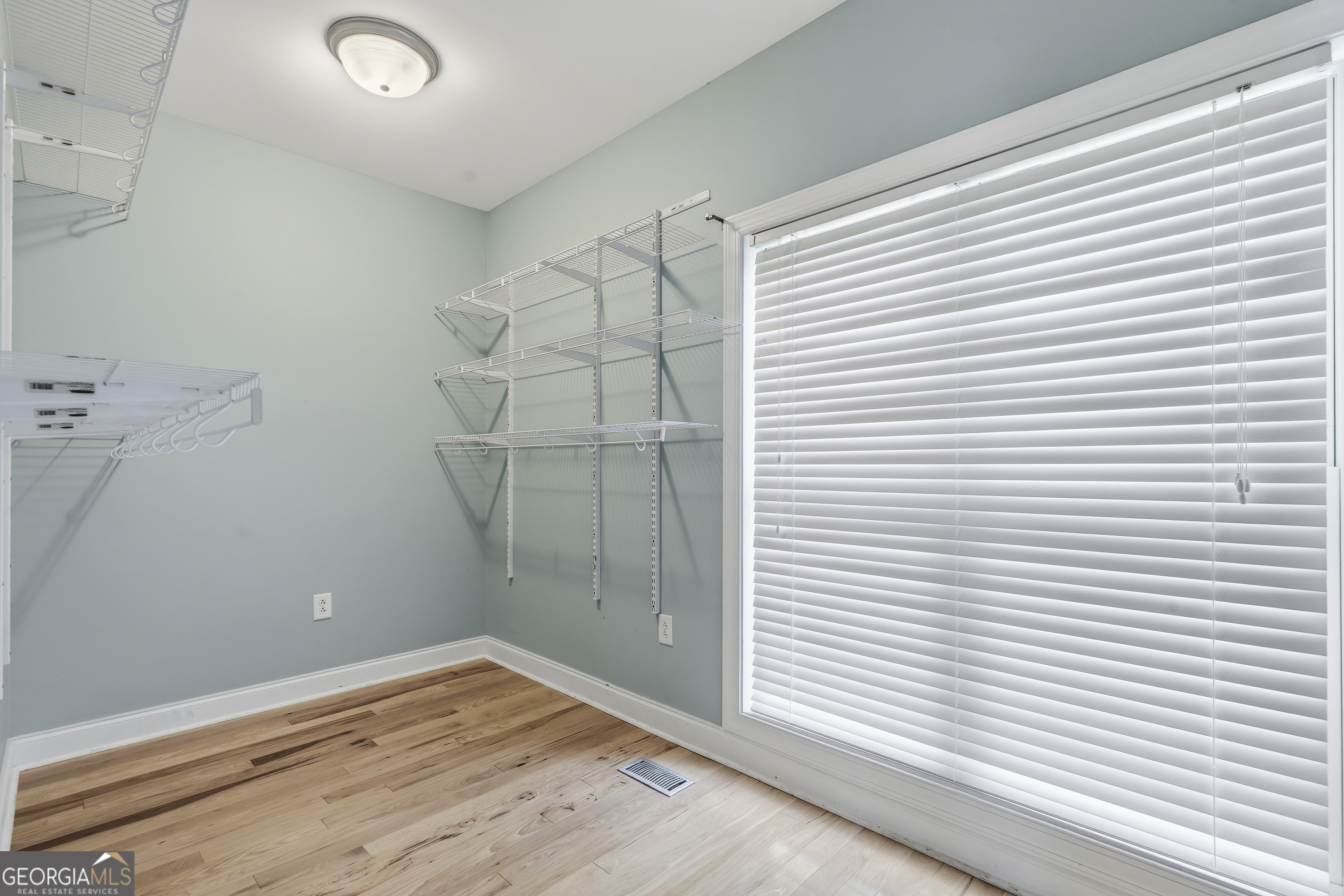 1038 Dennis Station Road Southwest Eatonton, GA 31024 - Photo 42 of 72 a view of a room with wooden floor and a window