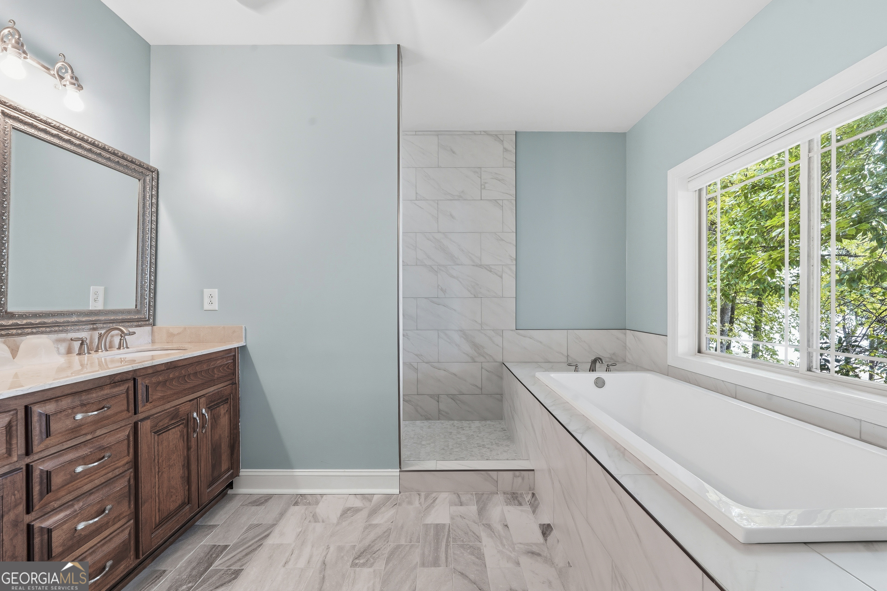 1038 Dennis Station Road Southwest Eatonton, GA 31024 - Photo 44 of 72 a bathroom with a tub sink and mirror