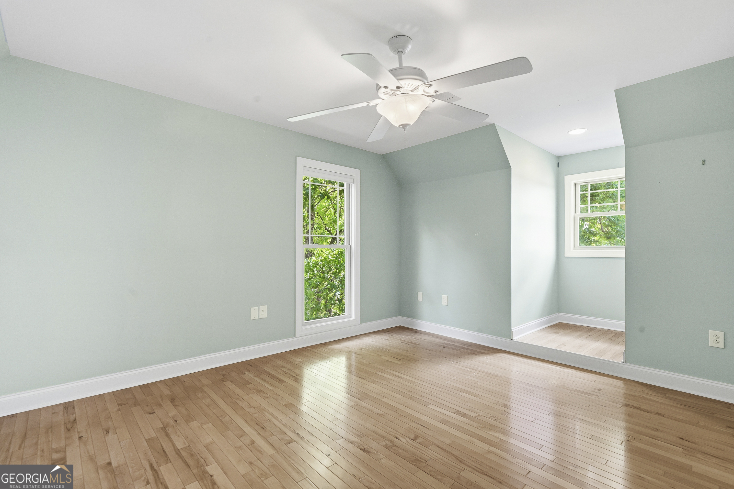 1038 Dennis Station Road Southwest Eatonton, GA 31024 - Photo 50 of 72 a view of an empty room with wooden floor and a window