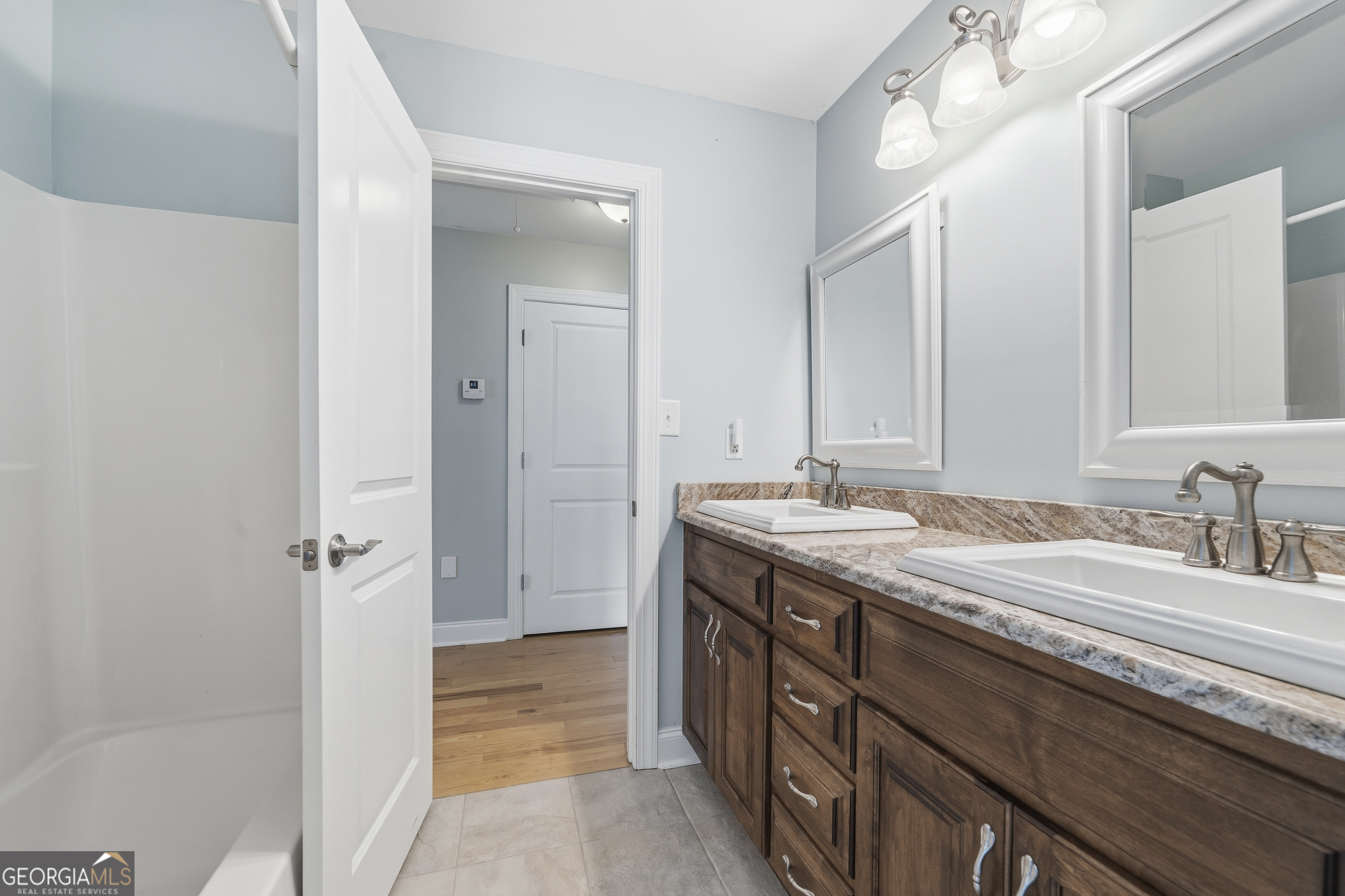 1038 Dennis Station Road Southwest Eatonton, GA 31024 - Photo 53 of 72 a bathroom with a granite countertop sink and a mirror