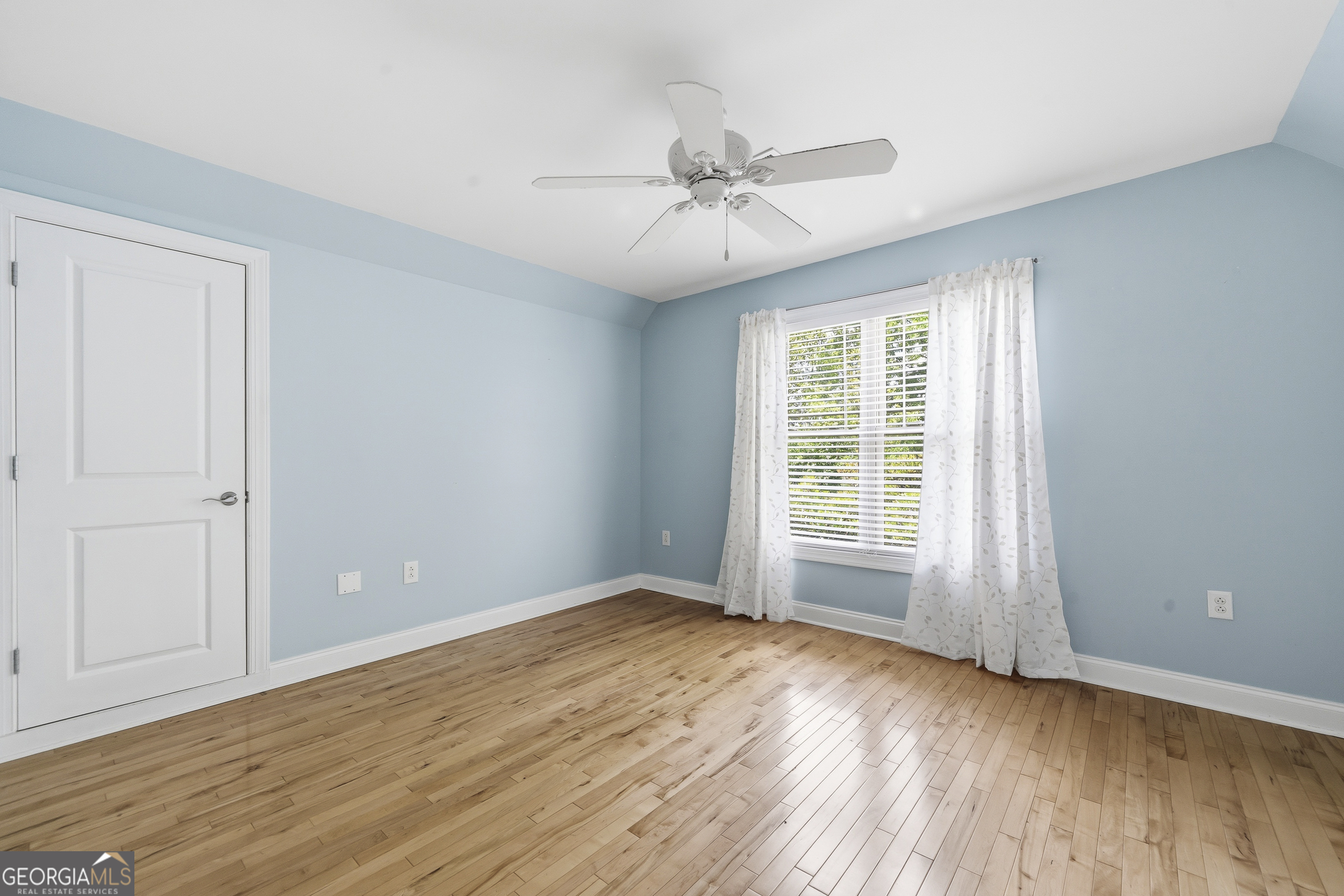 1038 Dennis Station Road Southwest Eatonton, GA 31024 - Photo 54 of 72 a view of an empty room with wooden floor and a window