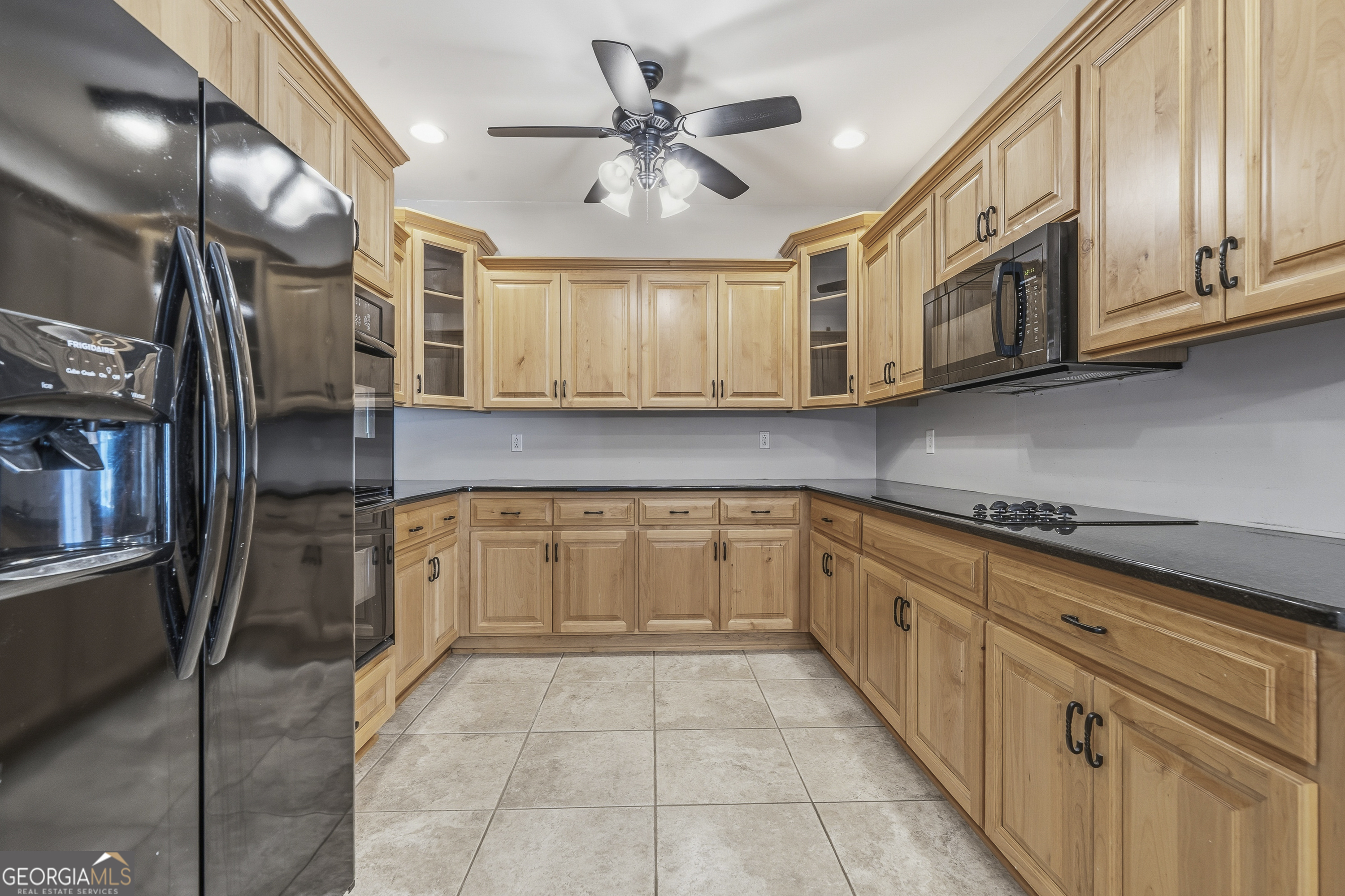 1038 Dennis Station Road Southwest Eatonton, GA 31024 - Photo 63 of 72 a kitchen with stainless steel appliances granite countertop a refrigerator and cabinets
