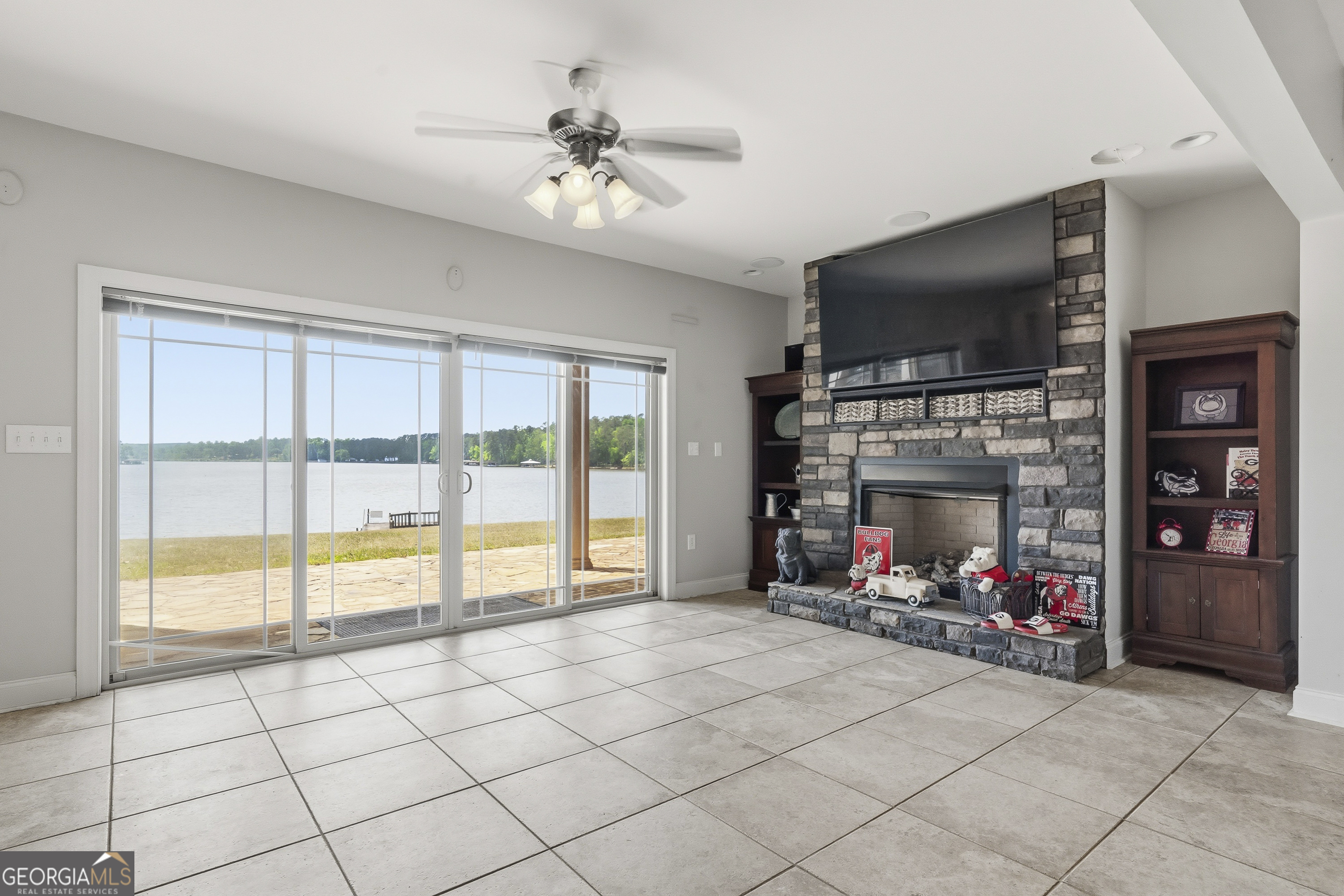 1038 Dennis Station Road Southwest Eatonton, GA 31024 - Photo 68 of 72 a view of an empty room with a fireplace and a flat screen tv