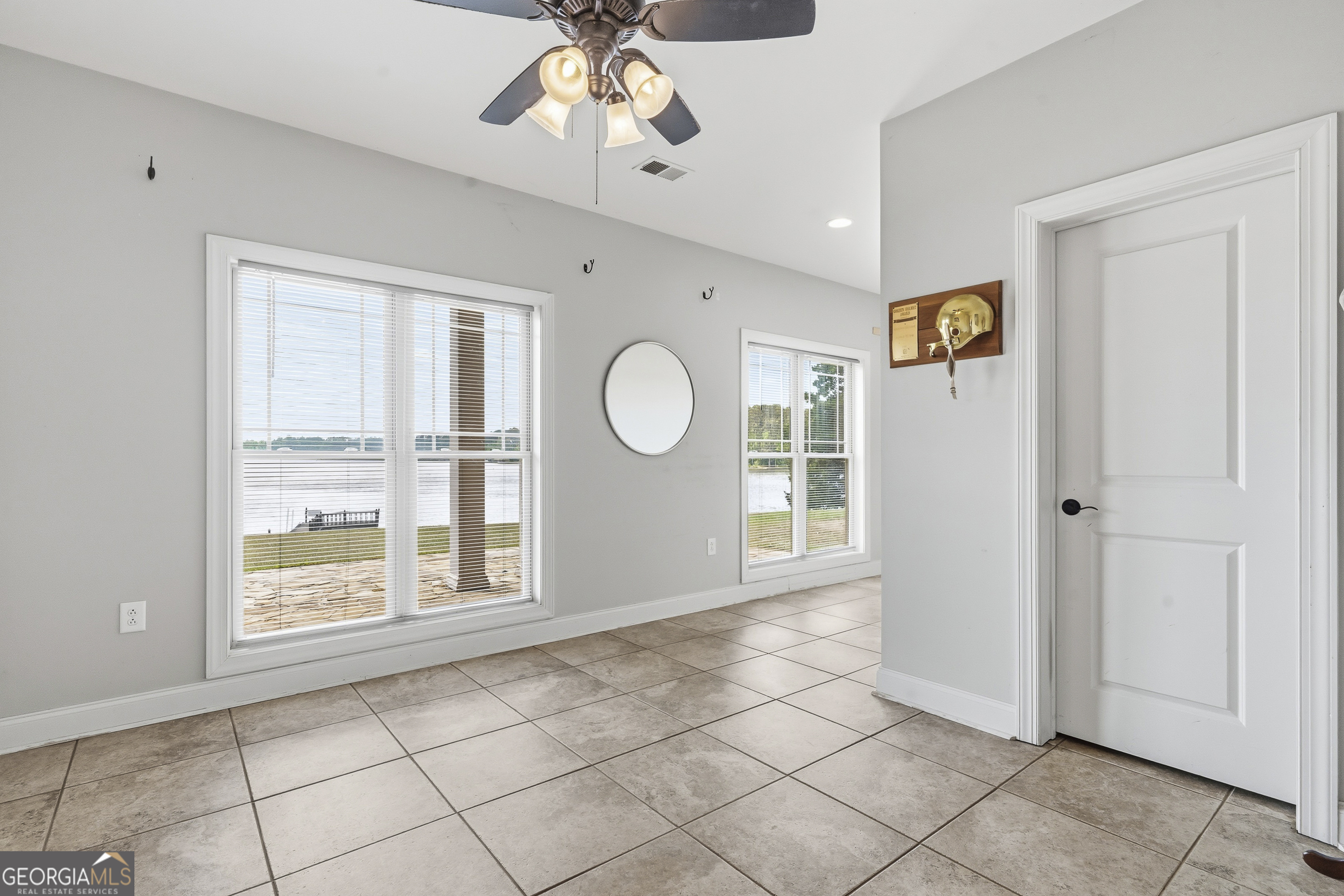 1038 Dennis Station Road Southwest Eatonton, GA 31024 - Photo 70 of 72 a view of a livingroom with a chandelier fan and windows