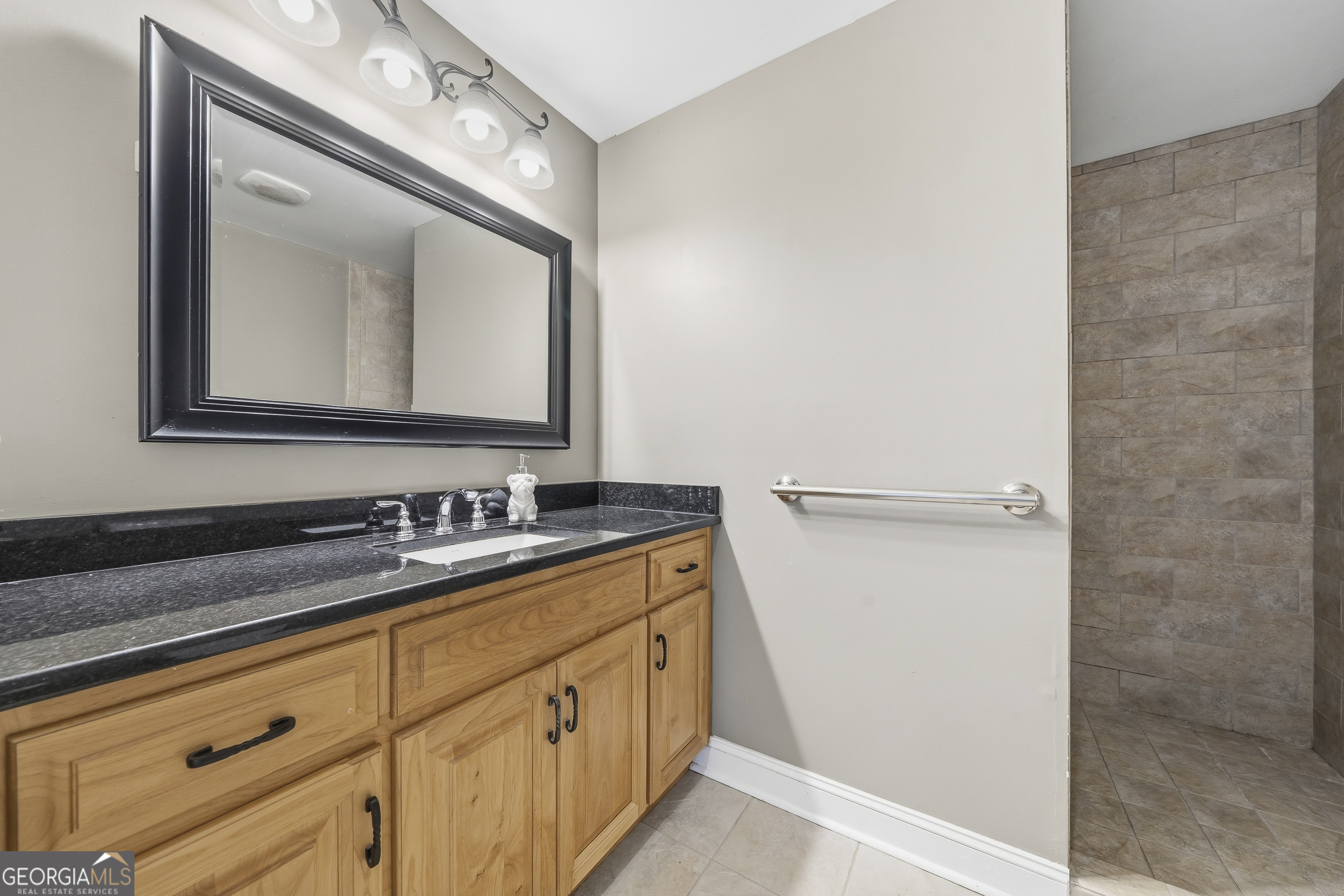 1038 Dennis Station Road Southwest Eatonton, GA 31024 - Photo 72 of 72 a bathroom with a double vanity sink and mirror
