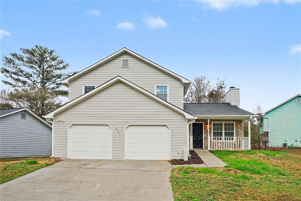 a front view of house with yard and green space