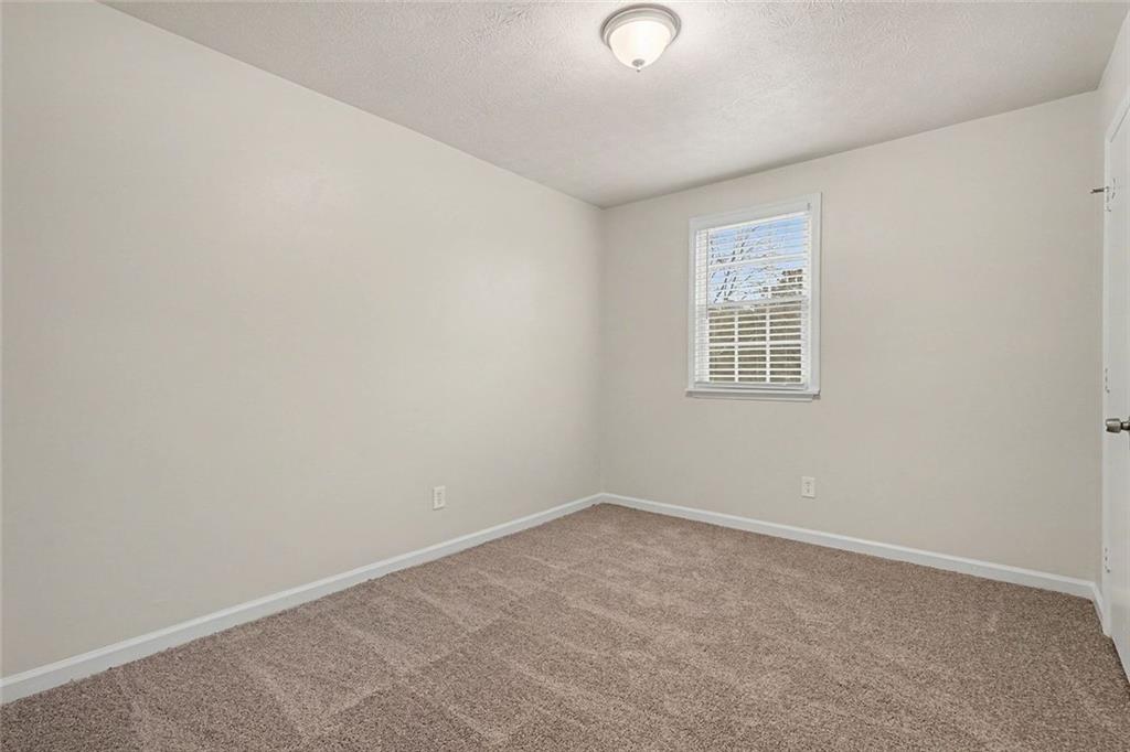 5571 Tunbridge Wells Road Lithonia, GA 30058 - Photo 13 of 23 an empty room with a window