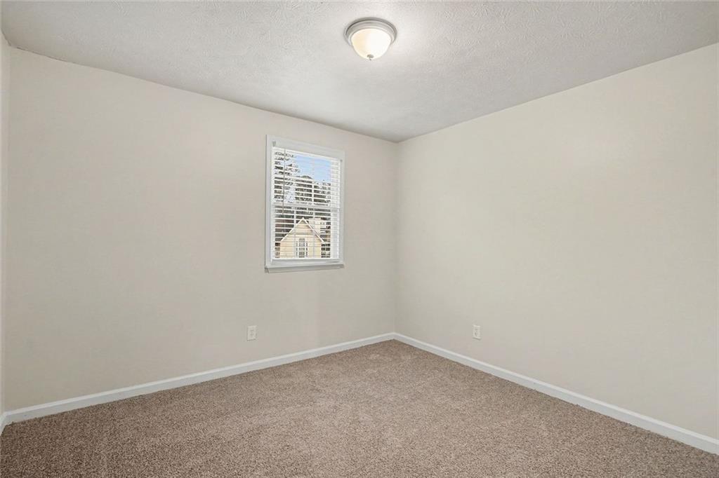 5571 Tunbridge Wells Road Lithonia, GA 30058 - Photo 15 of 23 an empty room with a window