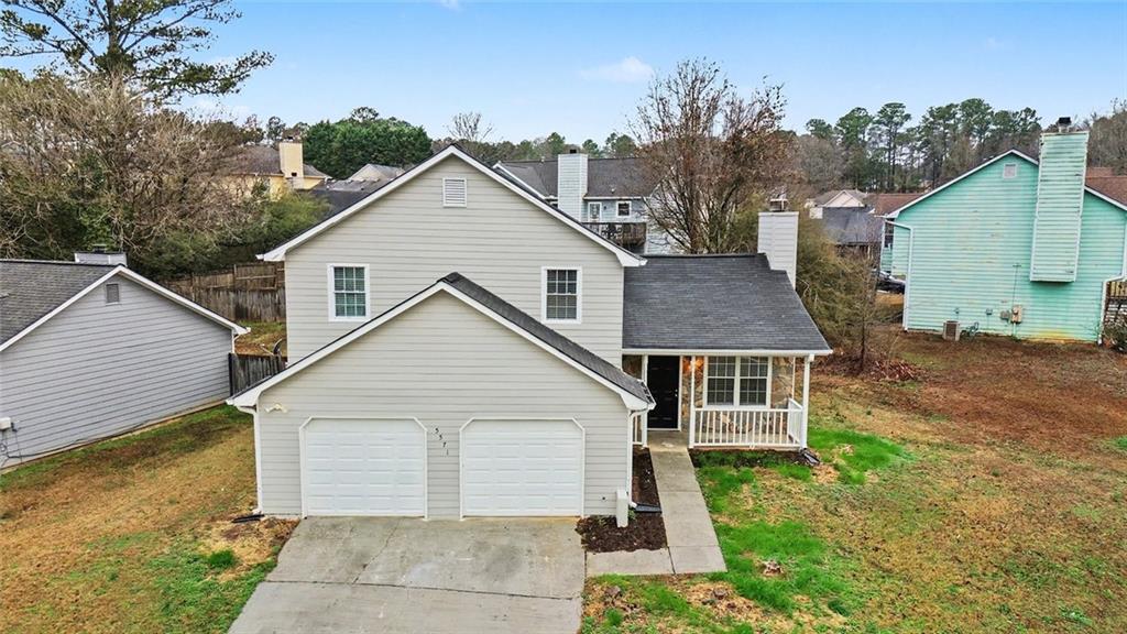 5571 Tunbridge Wells Road Lithonia, GA 30058 - Photo 20 of 23 a view of a house with a yard and potted plants