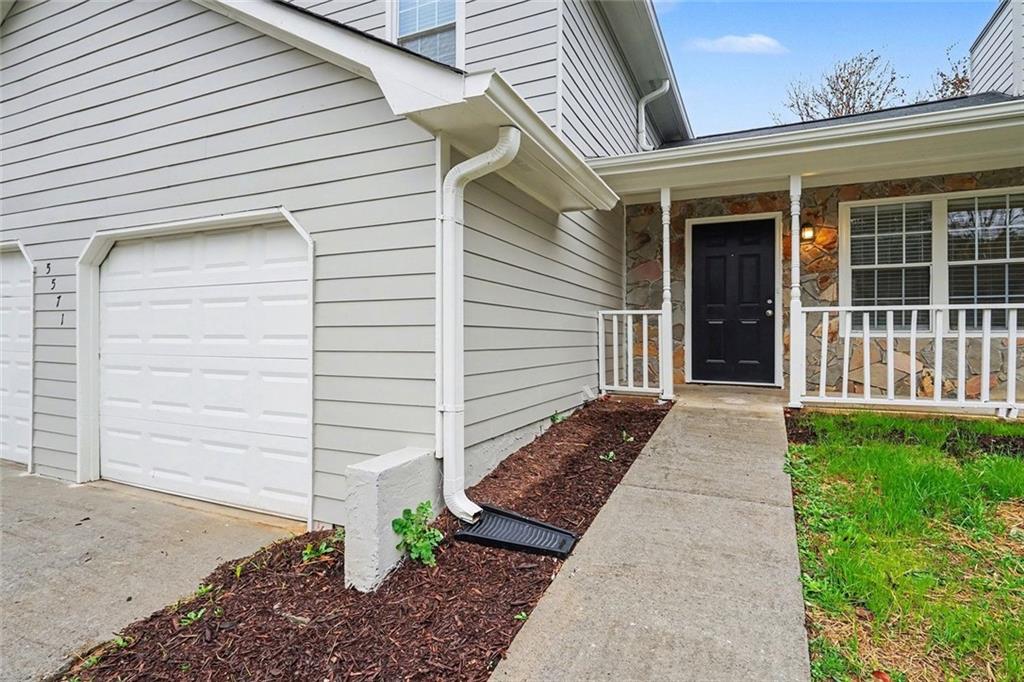 5571 Tunbridge Wells Road Lithonia, GA 30058 - Photo 3 of 23 a front view of a house with a yard