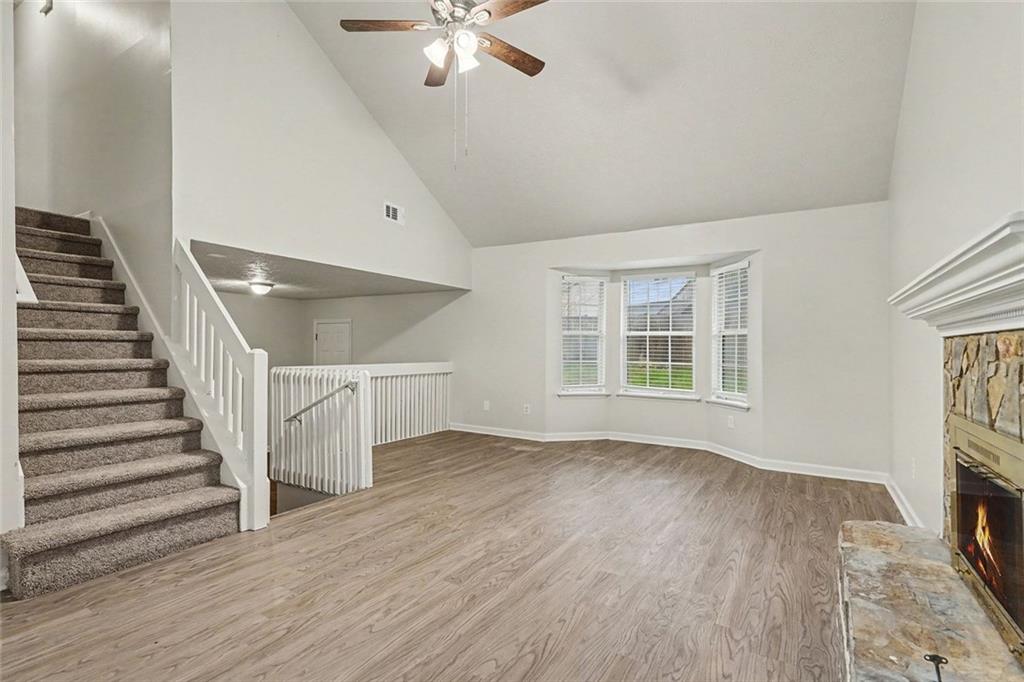 5571 Tunbridge Wells Road Lithonia, GA 30058 - Photo 4 of 23 a view of an empty room with wooden floor and a window