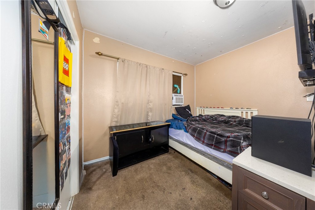 566 South Sage Avenue Rialto, CA 92376 - Photo 20 of 28 a bed room with a bed and a television