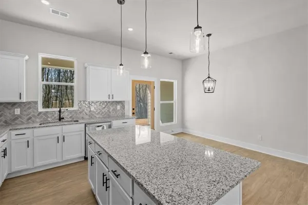 a kitchen with sink and center island