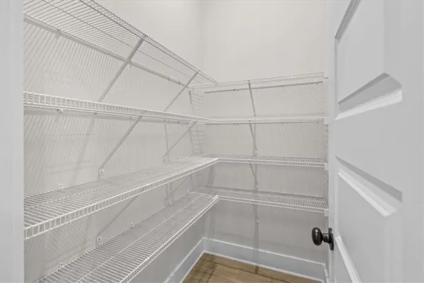 a view of small space with wooden floor and a window