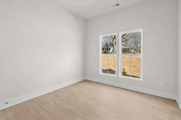 an empty room with wooden floor