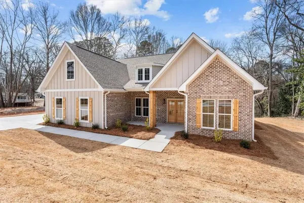 a view of a house with a yard covered in snow