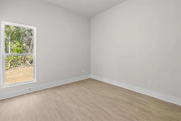 a view of a room with wooden floor