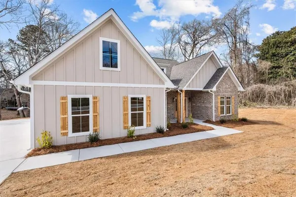 a view of a house with a yard covered in snow