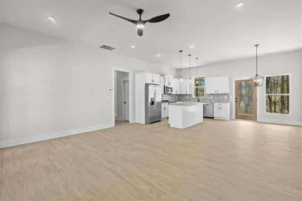 a view of a kitchen with refrigerator and a kitchen counter top space