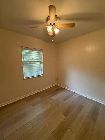 a view of a room with wooden floor and chandelier