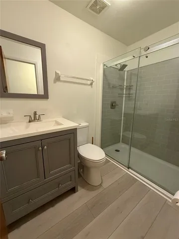 a bathroom with a toilet a sink and shower