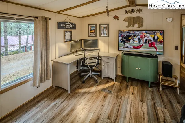 a living room with furniture and a floor to ceiling window