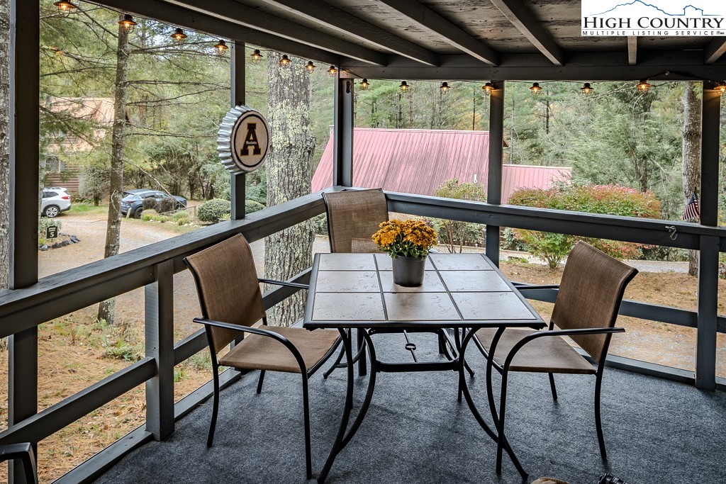 135 Mountain Ivy Lane Boone, NC 28607 - Photo 16 of 29 a view of a chairs and table in the roof deck