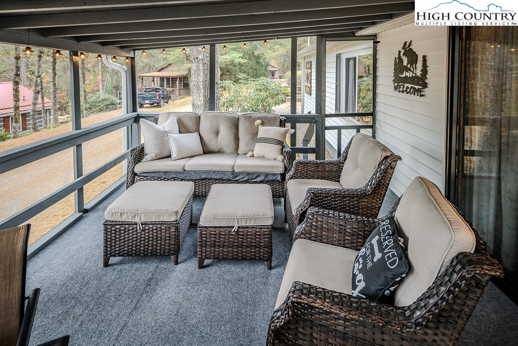 135 Mountain Ivy Lane Boone, NC 28607 - Photo 17 of 29 a living room with furniture and a floor to ceiling window