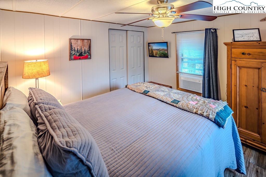 135 Mountain Ivy Lane Boone, NC 28607 - Photo 19 of 29 a bedroom with a bed and a lamp