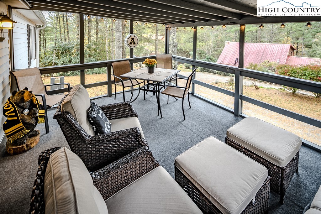 135 Mountain Ivy Lane Boone, NC 28607 - Photo 3 of 29 a living room with furniture and a floor to ceiling window