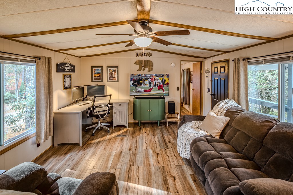 135 Mountain Ivy Lane Boone, NC 28607 - Photo 6 of 29 a living room with furniture ceiling fan and a window