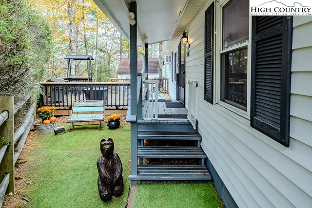 a view of a patio with couches table and chairs and wooden floor