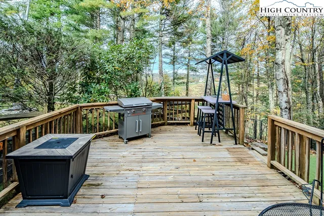 a view of a deck with wooden floor and outdoor seating