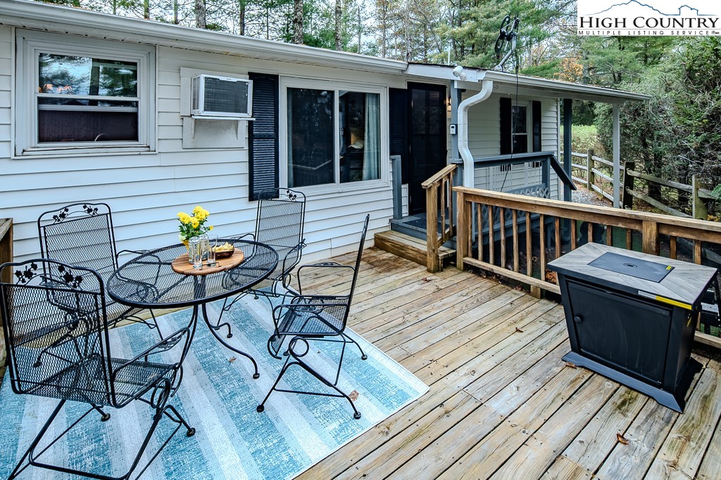 135 Mountain Ivy Lane Boone, NC 28607 - Photo 10 of 29 a view of a deck with wooden floor and outdoor seating