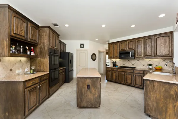 a kitchen with a sink stove and refrigerator