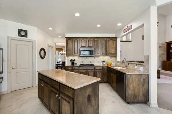 a kitchen with a sink stove and cabinets