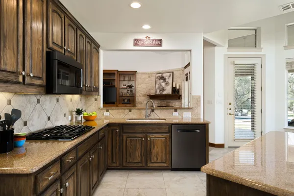 a kitchen with a sink cabinets and stainless steel appliances