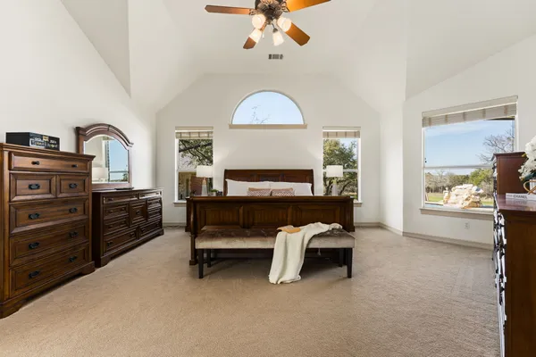 a large bathroom with a granite countertop double vanity sink and a bathtub