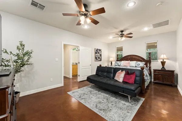 a bathroom with a granite countertop toilet a sink and mirror