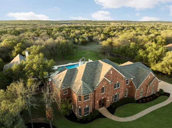 an aerial view of house with yard swimming pool and outdoor seating