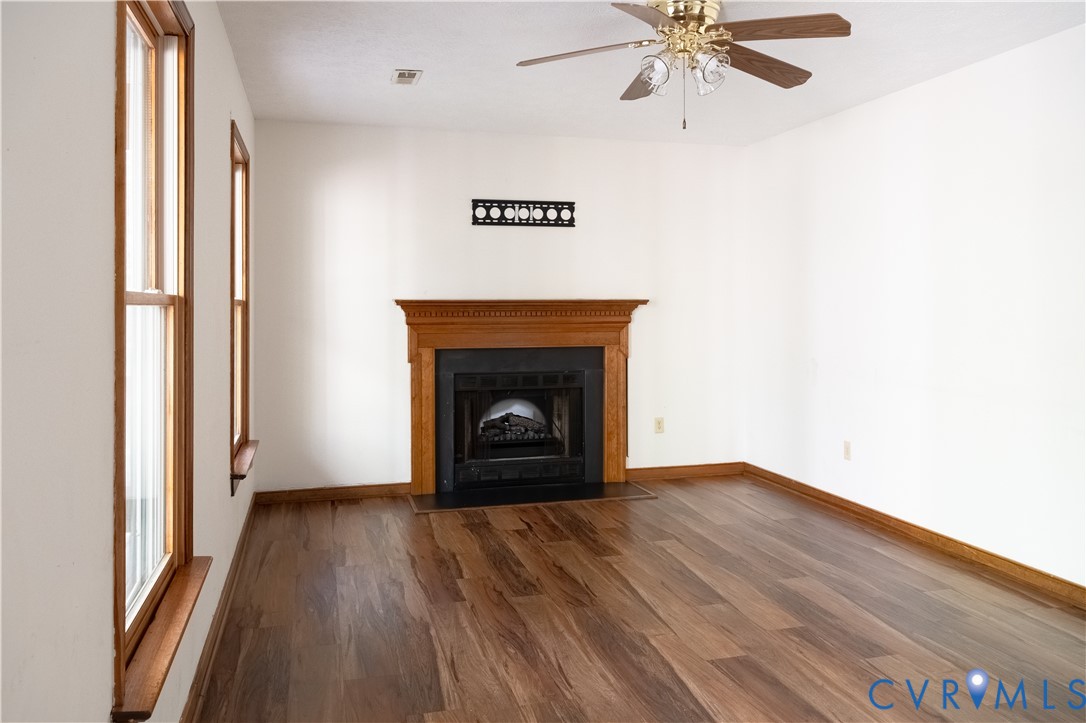 2477 Calno Road Hanover, VA 23069 - Photo 5 of 33 a view of a livingroom with wooden floor and a fireplace