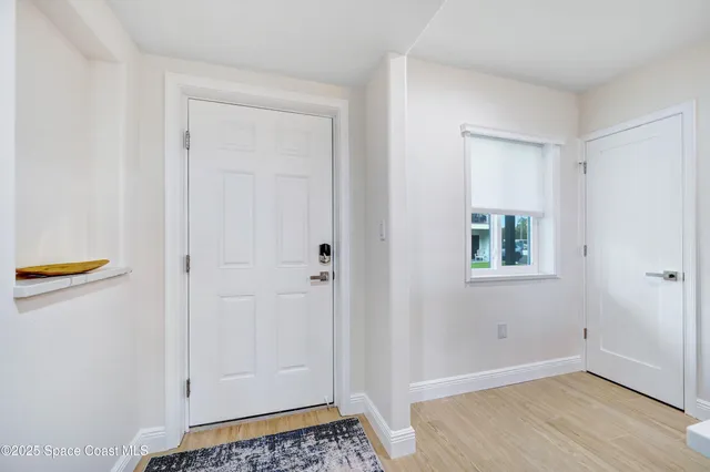 a living room with furniture wooden floor and a flat screen tv