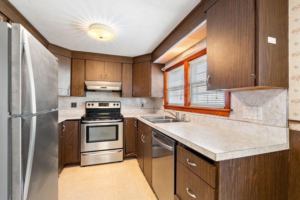 14 Hillside Road Braintree, MA 02184 - Photo 12 of 42 a kitchen with stainless steel appliances granite countertop a sink stove and refrigerator